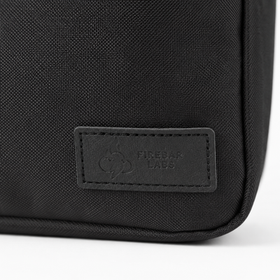 FireBar Labs Essential Messenger Bag — Black bag with embossed label detail