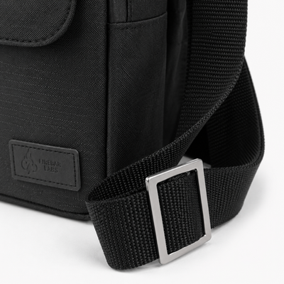 FireBar Labs Essential Messenger Bag — Black bag with textured fabric and label